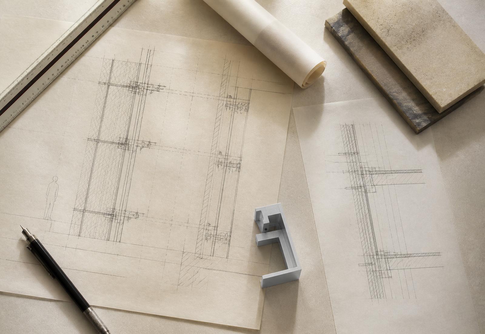 Technical setting-out drawings, scale rule and section details laid out on a drawing board