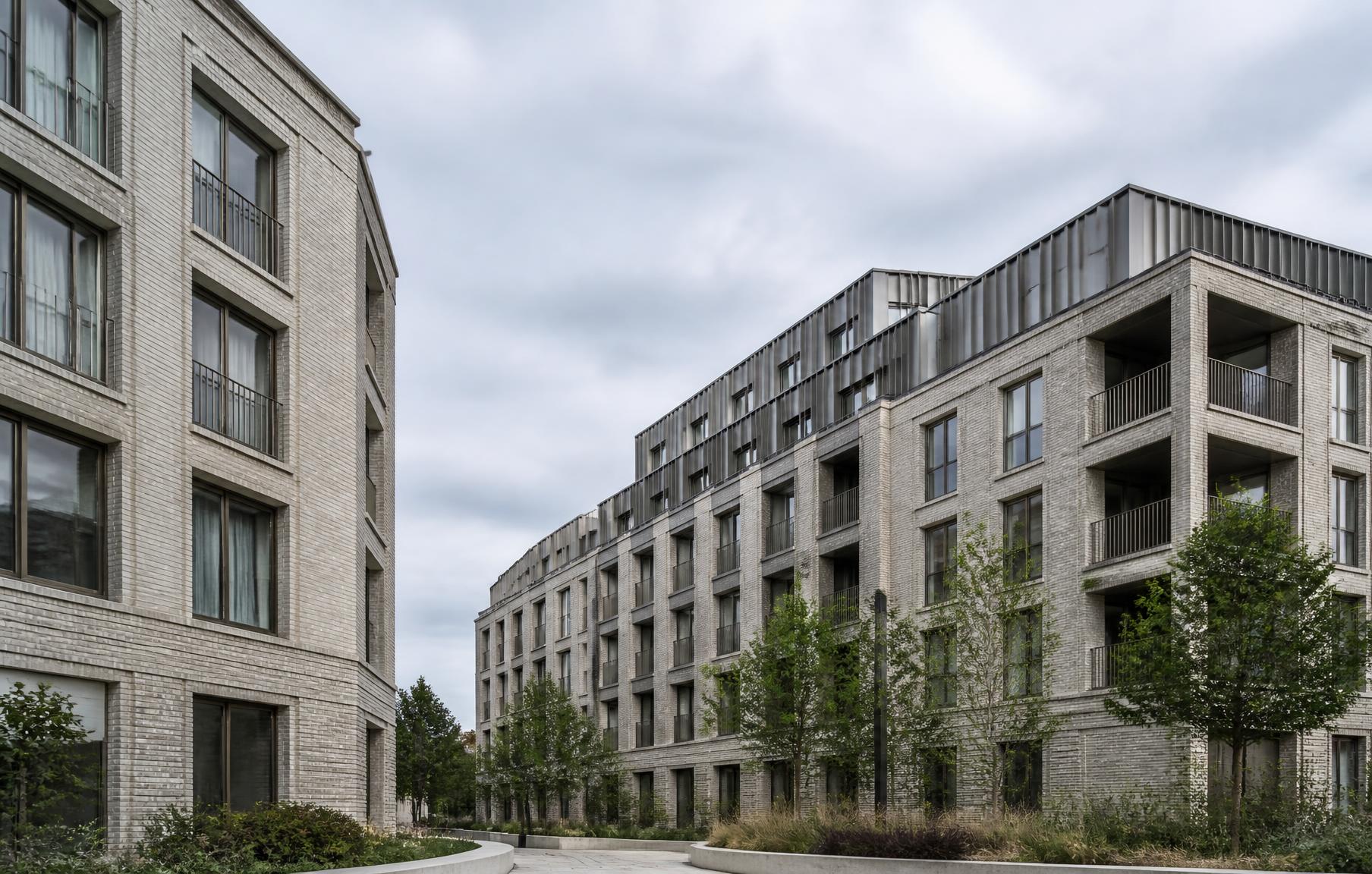Exterior view of a contemporary mixed-use residential development in West London with pale brick and metal facades
